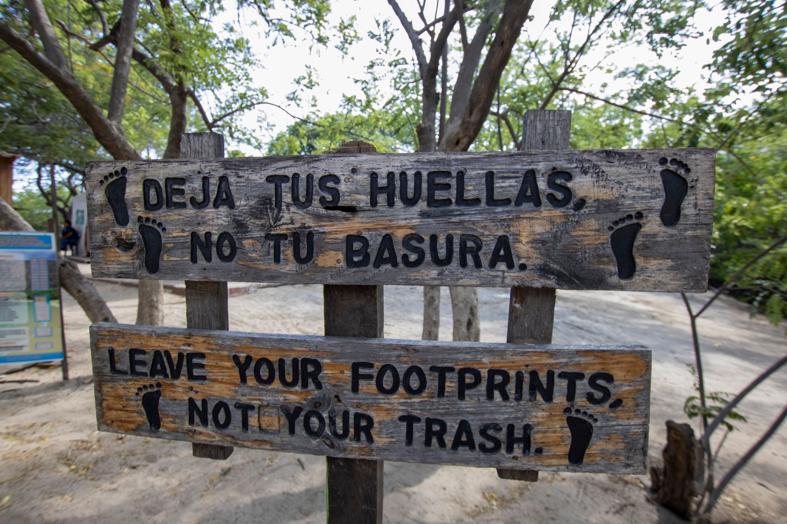 Wooden sign promoting nature preservation in a lush outdoor area ethical tourism