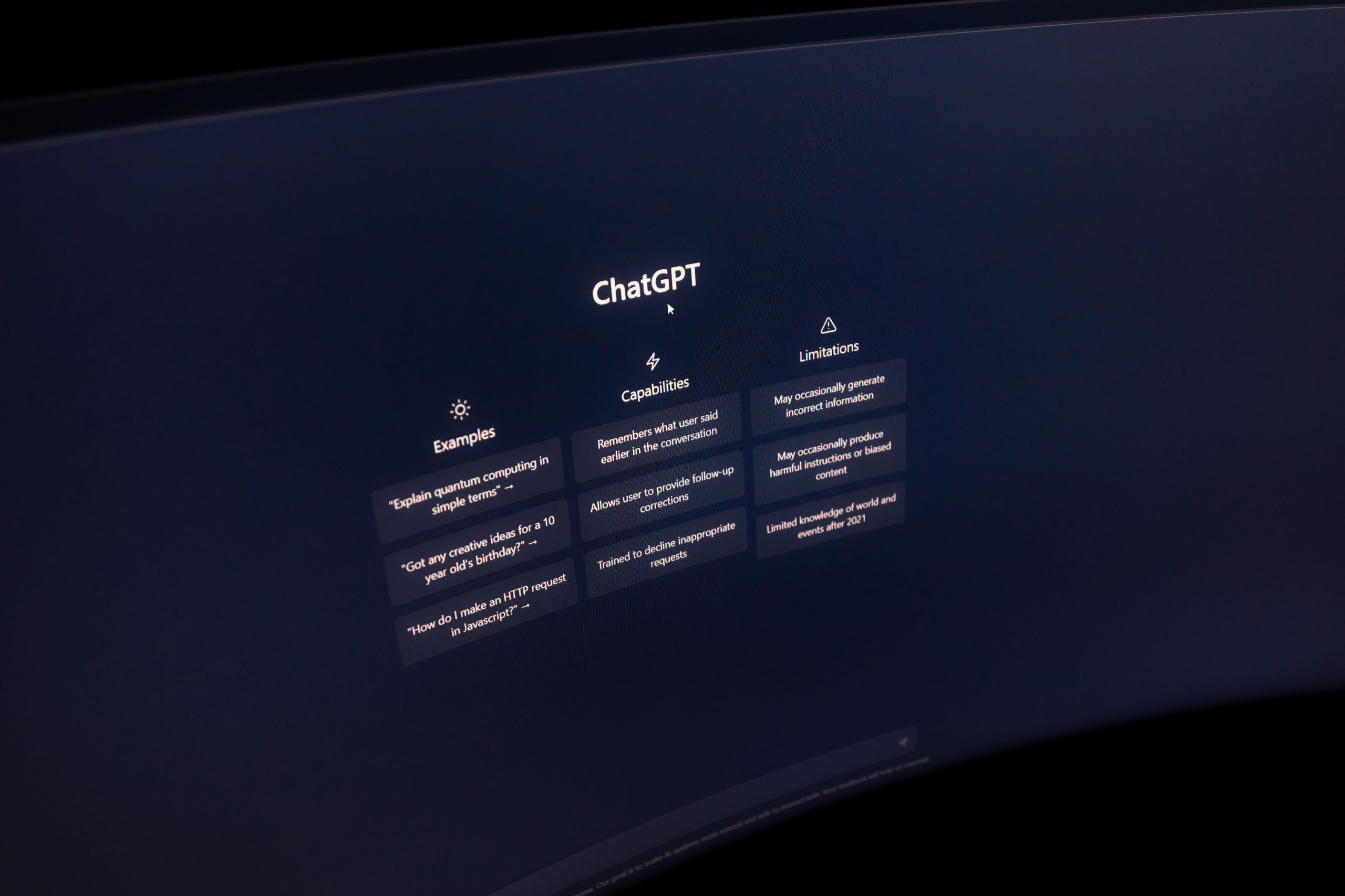 Close-up of a computer screen displaying ChatGPT interface in a dark setting AI